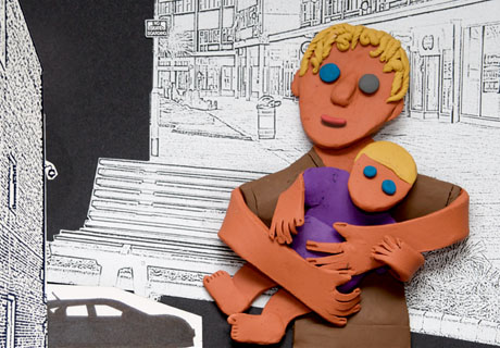 single frame from the film show Kaleb with a baby in his arms