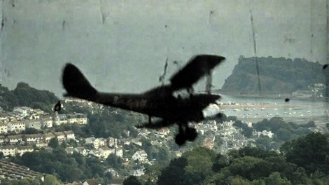 Still from the film Teign Spirit showing biplane over Teignmouth